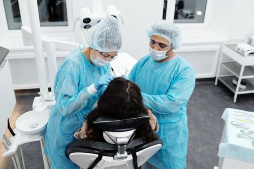 Dentista atendiendo a una paciente en un consultorio moderno